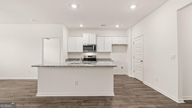 kitchen with recessed lighting, white cabinetry, stone countertops, and stainless steel appliances