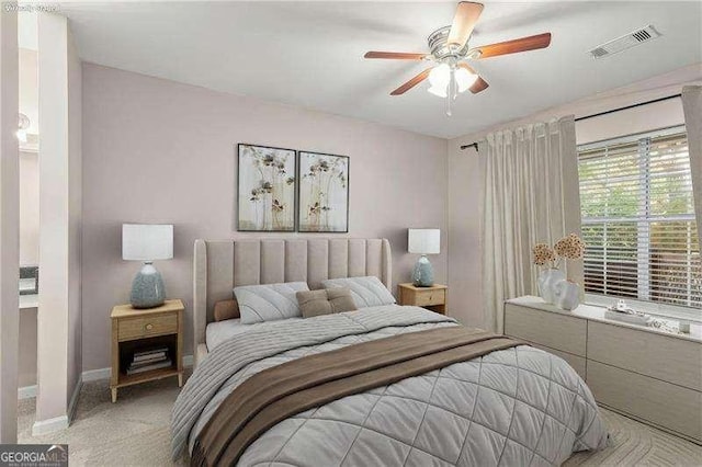 carpeted bedroom with visible vents, ceiling fan, and baseboards