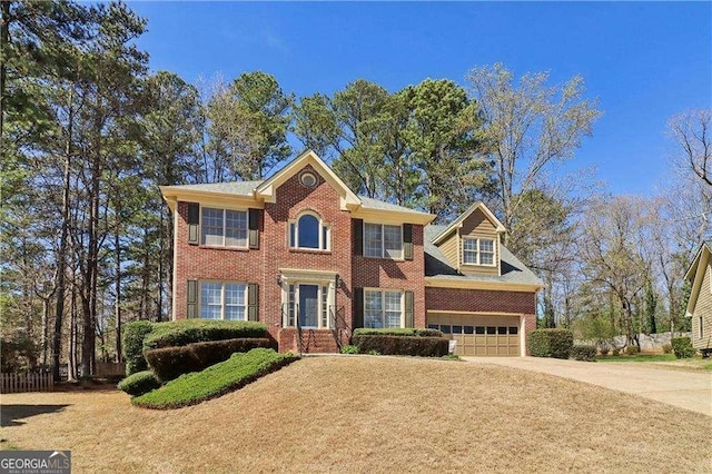 colonial house with concrete driveway, a garage, and brick siding