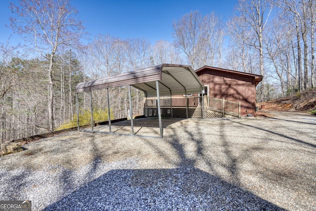 view of vehicle parking with a detached carport and aphalt driveway