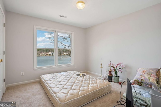 carpeted bedroom featuring baseboards and visible vents