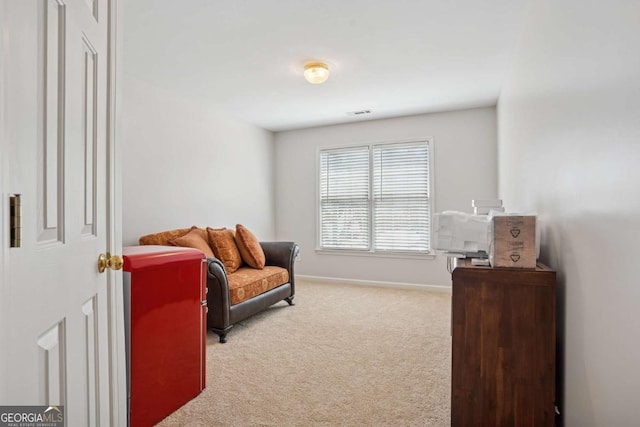 living area featuring carpet floors and baseboards