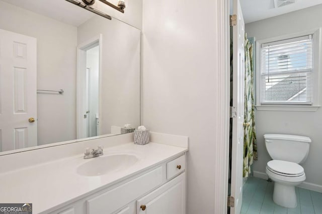 bathroom featuring tile patterned flooring, vanity, toilet, baseboards, and visible vents