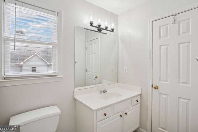 bathroom with toilet and vanity