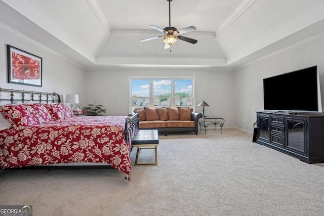 bedroom with ceiling fan, carpet floors, ornamental molding, and a raised ceiling