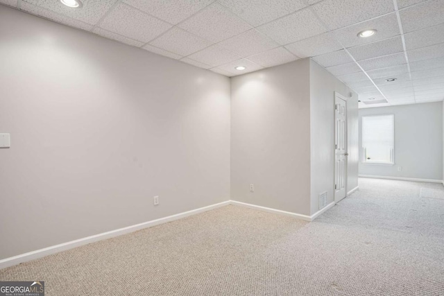 interior space featuring baseboards, visible vents, and a paneled ceiling