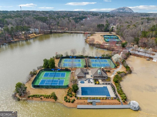 drone / aerial view with a water view and a view of trees