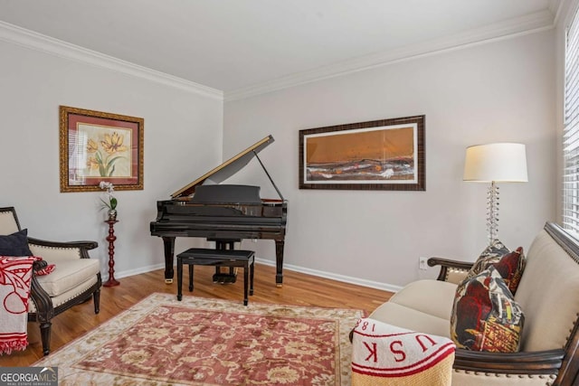 living area featuring baseboards, crown molding, and wood finished floors