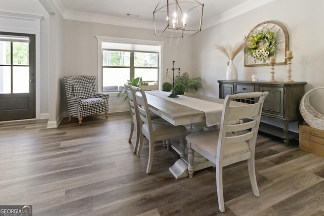 dining space with crown molding, wood finished floors, a notable chandelier, and a healthy amount of sunlight