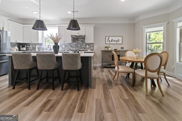 kitchen featuring plenty of natural light, light countertops, freestanding refrigerator, and tasteful backsplash