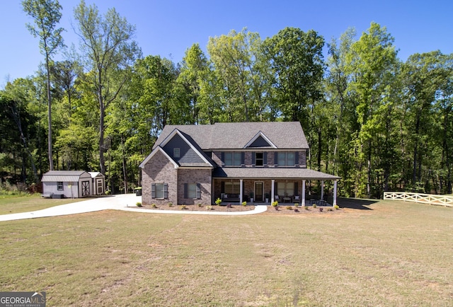 view of front of house with an outdoor structure, a shed, a porch, and a front yard