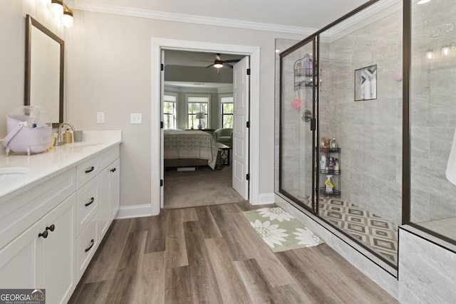 ensuite bathroom with a sink, wood finished floors, a shower stall, crown molding, and connected bathroom