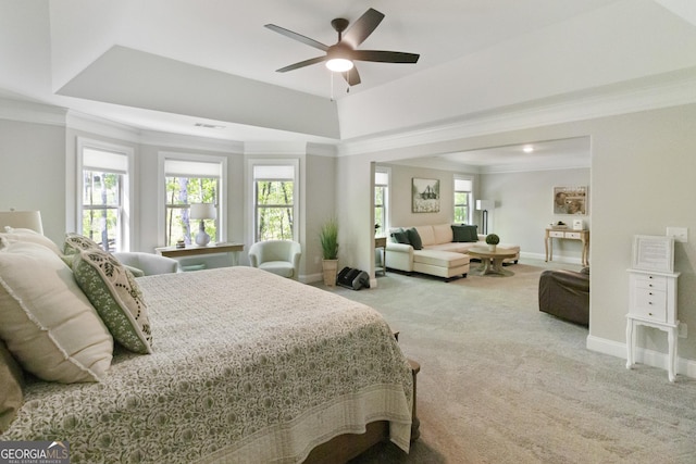 carpeted bedroom with multiple windows, baseboards, and crown molding