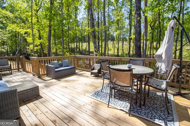 wooden terrace featuring outdoor dining area