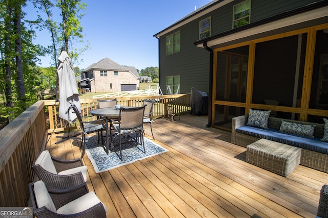 wooden terrace with outdoor dining space