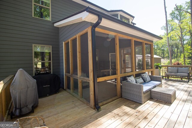wooden deck with grilling area, a sunroom, and an outdoor hangout area