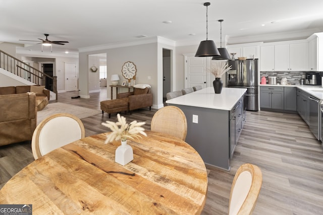 dining room with ornamental molding, recessed lighting, light wood-style floors, and ceiling fan