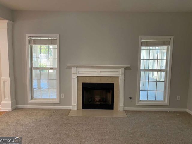 1295 Leisure Lake Dr, Lawrenceville, GA 30044 - unfurnished living room featuring carpet flooring, a fireplace, and a wealth of natural light