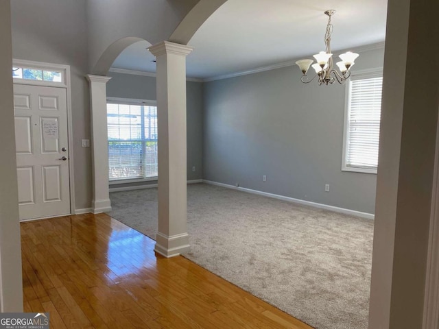 1295 Leisure Lake Dr, Lawrenceville, GA 30044 - carpeted foyer featuring crown molding, baseboards, arched walkways, and ornate columns