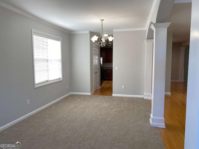 1295 Leisure Lake Dr, Lawrenceville, GA 30044 - unfurnished dining area with carpet flooring, baseboards, a notable chandelier, and crown molding