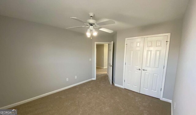 1295 Leisure Lake Dr, Lawrenceville, GA 30044 - unfurnished bedroom with a closet, carpet flooring, a ceiling fan, and baseboards