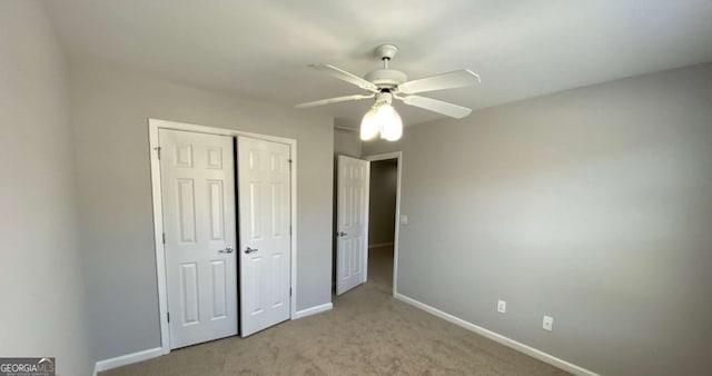 1295 Leisure Lake Dr, Lawrenceville, GA 30044 - unfurnished bedroom featuring ceiling fan, baseboards, a closet, and light carpet