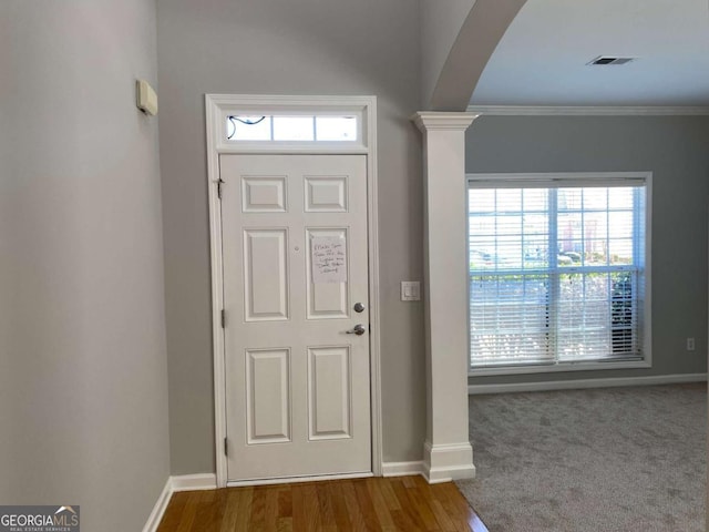 1295 Leisure Lake Dr, Lawrenceville, GA 30044 - entrance foyer with visible vents, arched walkways, crown molding, baseboards, and ornate columns