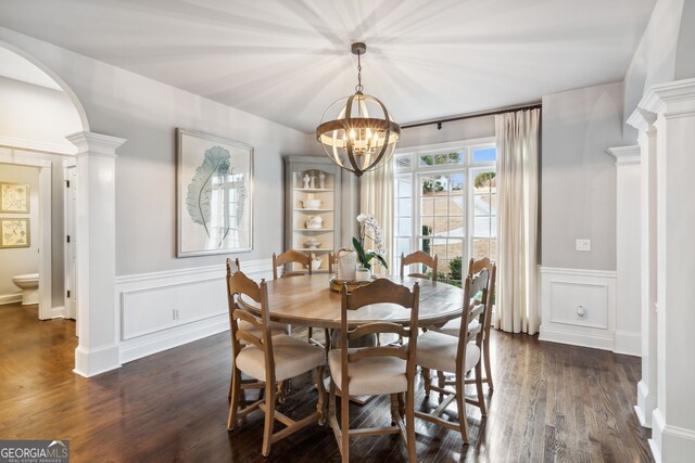 8625 Anchor On Lanier Ct, Gainesville, GA 30506 - dining space featuring ornate columns, a chandelier, dark wood-style floors, a wainscoted wall, and a decorative wall
