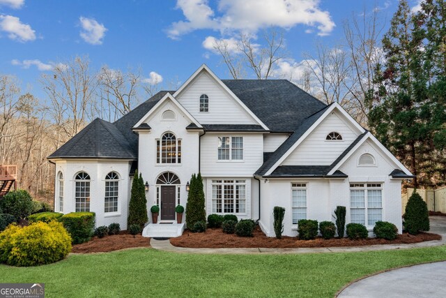 8625 Anchor On Lanier Ct, Gainesville, GA 30506 - french country home featuring a front yard and a shingled roof