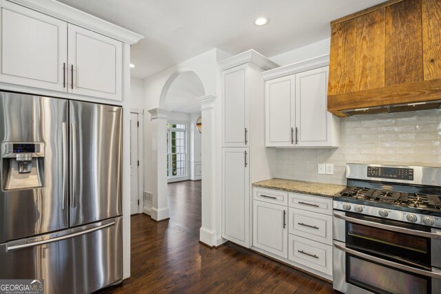 8625 Anchor On Lanier Ct, Gainesville, GA 30506 - kitchen with stainless steel appliances, arched walkways, decorative columns, tasteful backsplash, and white cabinetry