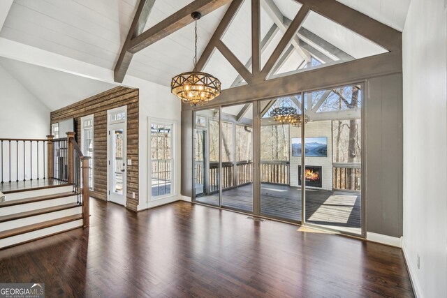 8625 Anchor On Lanier Ct, Gainesville, GA 30506 - unfurnished living room featuring a chandelier, high vaulted ceiling, wood finished floors, stairway, and beamed ceiling