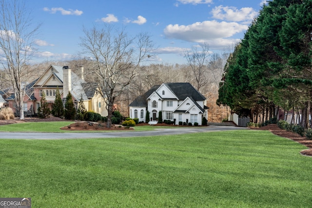 8625 Anchor On Lanier Ct, Gainesville, GA 30506 - view of front of house featuring asphalt driveway, a chimney, and a front yard