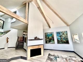 3810 Galloway Dr NE, Roswell, GA 30075 - living area featuring beamed ceiling, wood finished floors, high vaulted ceiling, and baseboards