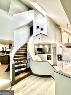 3810 Galloway Dr NE, Roswell, GA 30075 - living room with a high ceiling, light wood-type flooring, and stairs