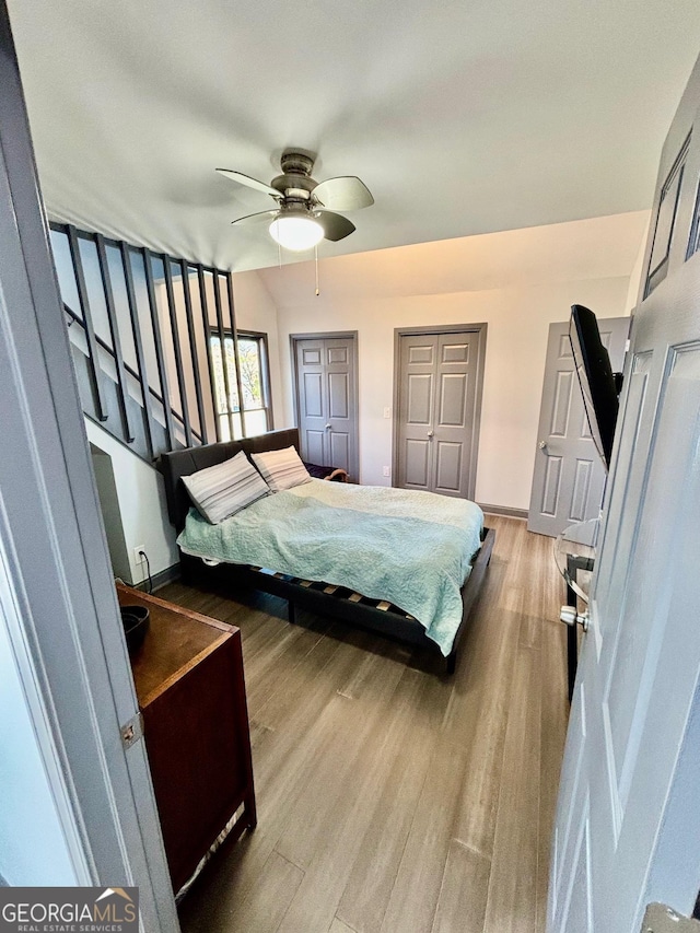 3810 Galloway Dr NE, Roswell, GA 30075 - bedroom featuring wood finished floors, baseboards, a ceiling fan, and two closets