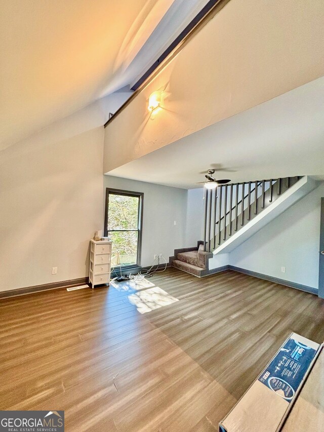 3810 Galloway Dr NE, Roswell, GA 30075 - unfurnished living room featuring wood finished floors, stairway, baseboards, vaulted ceiling, and ceiling fan