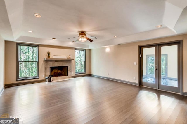 3810 Galloway Dr NE, Roswell, GA 30075 - unfurnished living room with a tray ceiling, baseboards, wood finished floors, a ceiling fan, and french doors