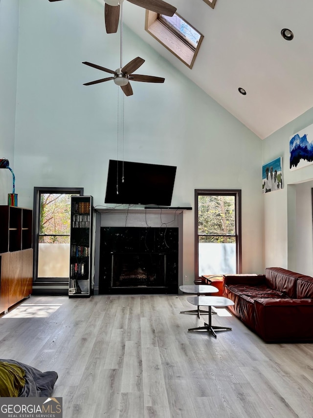 3810 Galloway Dr NE, Roswell, GA 30075 - living area featuring high vaulted ceiling, a ceiling fan, plenty of natural light, wood finished floors, and a high end fireplace