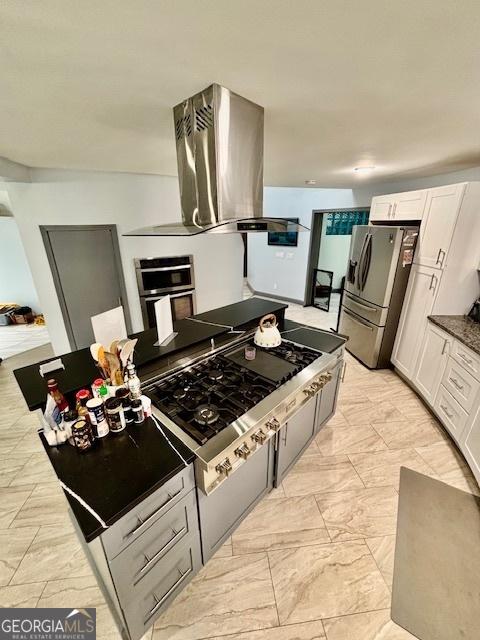 3810 Galloway Dr NE, Roswell, GA 30075 - kitchen with stainless steel appliances, island exhaust hood, white cabinetry, and light marble finish floors
