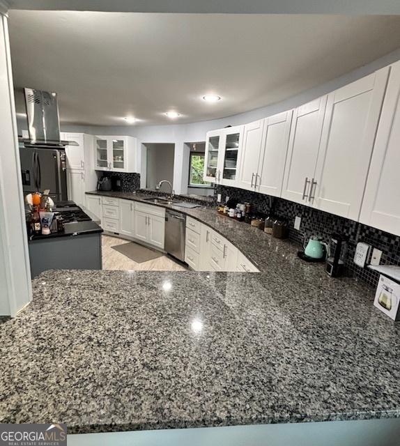 3810 Galloway Dr NE, Roswell, GA 30075 - kitchen featuring island exhaust hood, dishwasher, glass insert cabinets, dark stone countertops, and recessed lighting