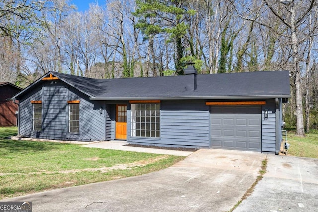 view of front of home featuring a front lawn, concrete driveway, and an attached garage