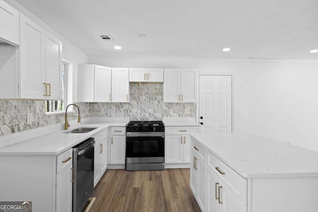 kitchen with a sink, visible vents, appliances with stainless steel finishes, and white cabinetry