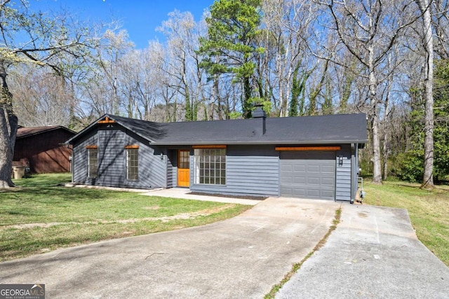 view of front of property with a garage, concrete driveway, and a front yard