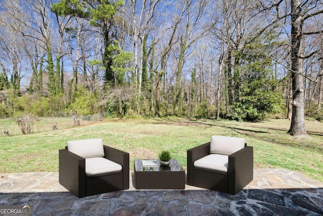 view of patio featuring an outdoor living space and a wooded view