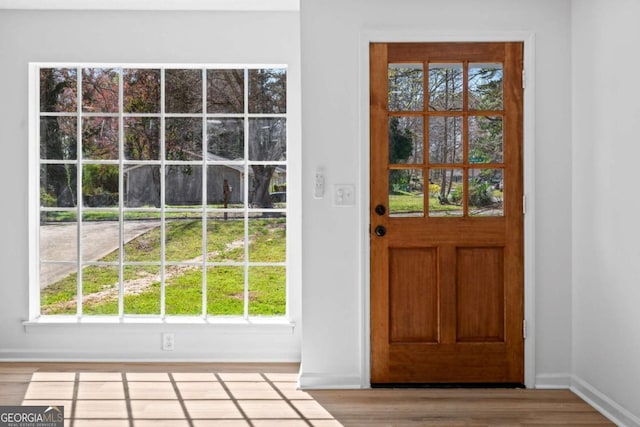 doorway featuring baseboards