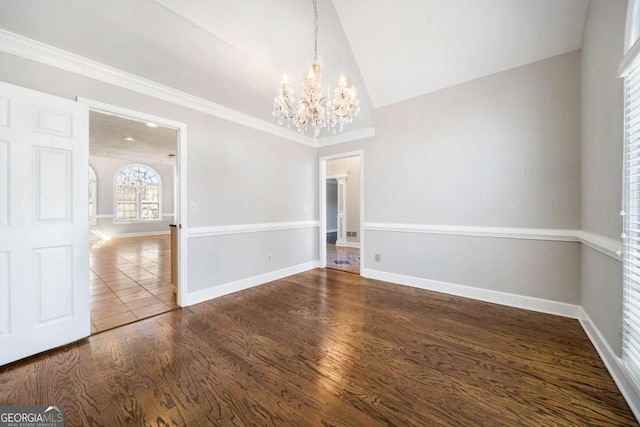 931 New Bedford Dr, Marietta, GA 30068 - unfurnished dining area with wood finished floors, baseboards, an inviting chandelier, lofted ceiling, and ornamental molding