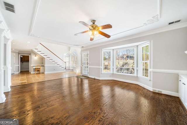 931 New Bedford Dr, Marietta, GA 30068 - unfurnished living room with visible vents, wood finished floors, and stairway