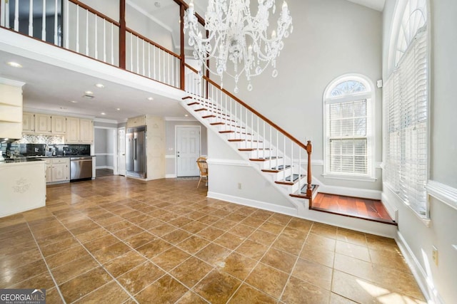 931 New Bedford Dr, Marietta, GA 30068 - unfurnished living room with dark tile patterned floors, stairway, baseboards, and a towering ceiling