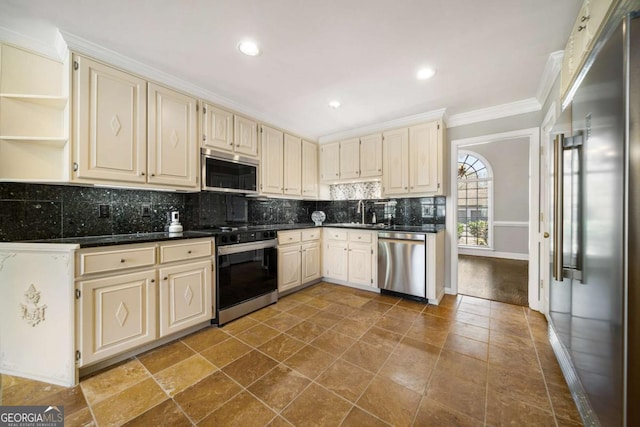 931 New Bedford Dr, Marietta, GA 30068 - kitchen with dark countertops, cream cabinetry, and appliances with stainless steel finishes