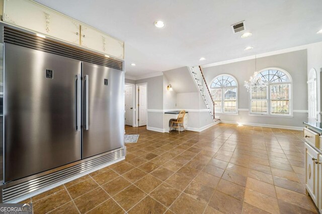931 New Bedford Dr, Marietta, GA 30068 - kitchen featuring visible vents, crown molding, baseboards, cream cabinetry, and built in fridge